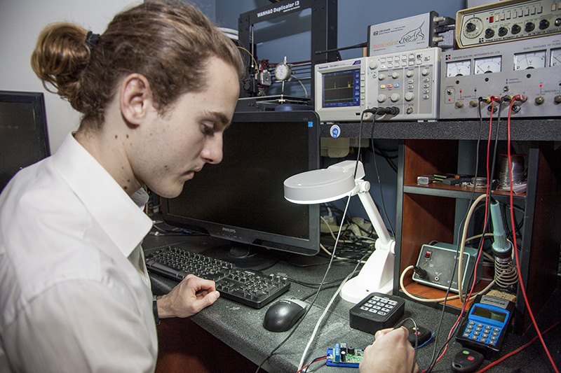 An engineer testing GuardCell electronics on a workbench