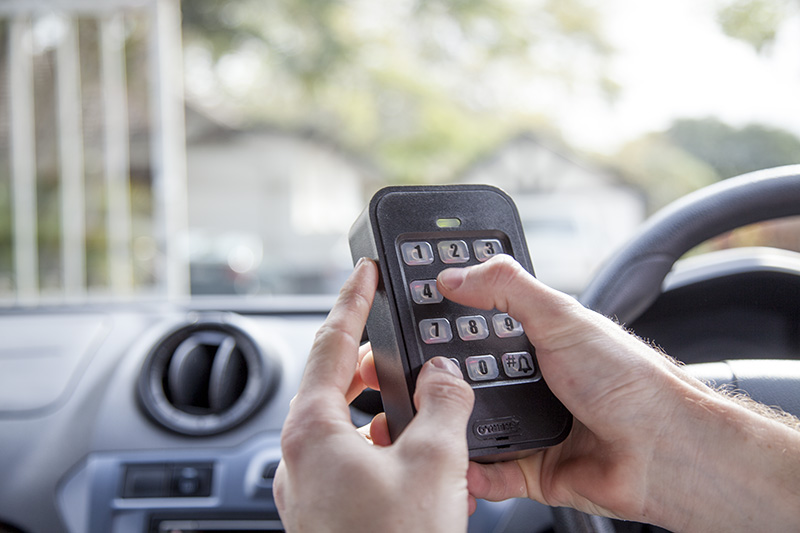 A reaction officer entering an access code on the GuardCell keypad inside a vehicle
